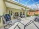 Spacious covered patio with a ceiling fan, hot tub, and outdoor seating at 3551 Mulberry Grove Loop, Leesburg, FL 34748
