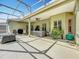 Large, screened-in patio area with a hot tub and ample space for entertaining at 3551 Mulberry Grove Loop, Leesburg, FL 34748