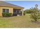 Exterior showcasing a screened-in patio and well-manicured backyard at 3656 Solana Cir # A, Clermont, FL 34711