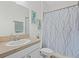 Bathroom featuring vanity, tile flooring, and shower with white and grey patterned shower curtain at 3656 Solana Cir # A, Clermont, FL 34711