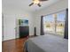 Bright bedroom boasts a large window with wood floors and a modern TV at 3656 Solana Cir # A, Clermont, FL 34711