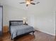 Comfortable bedroom featuring wood floors, a ceiling fan, and a neutral color palette at 3656 Solana Cir # A, Clermont, FL 34711