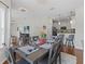 Dining area with wood floors, decorative chandelier, and open layout to the kitchen and living area at 3656 Solana Cir # A, Clermont, FL 34711