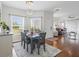 Bright dining area with wood floors, decorative chandelier, and views of the front yard at 3656 Solana Cir # A, Clermont, FL 34711