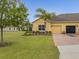 Charming home features a well-manicured lawn, brick driveway, and lush landscaping at 3656 Solana Cir # A, Clermont, FL 34711