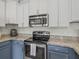 Modern kitchen features stainless steel appliances, granite countertops, and ample storage at 3656 Solana Cir # A, Clermont, FL 34711