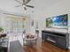 Bright living room features a sliding door, a TV, and access to other rooms at 3656 Solana Cir # A, Clermont, FL 34711