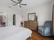 Main bedroom with wood floors, dresser, and sitting area, adjoining main bathroom and walk in closet at 3656 Solana Cir # A, Clermont, FL 34711
