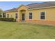 A quaint home exterior features a covered entrance and neatly trimmed shrubs at 3656 Solana Cir # A, Clermont, FL 34711