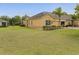 Spacious home exterior features a sprawling green lawn and mature trees at 3656 Solana Cir # A, Clermont, FL 34711