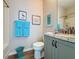 Cozy bathroom featuring granite countertops, gray cabinets, and a shower-tub combo at 368 Alcove Dr, Groveland, FL 34736