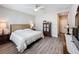 Comfortable bedroom with a ceiling fan, wooden-look tile flooring, and a dark wood dresser at 368 Alcove Dr, Groveland, FL 34736