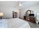 Bright bedroom with ceiling fan, wood-look floors, and ample furniture with a mirrored dresser at 368 Alcove Dr, Groveland, FL 34736