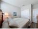 Cozy bedroom with a striped quilt, accent pillow, bedside lamp, and a closet with white sliding doors at 368 Alcove Dr, Groveland, FL 34736