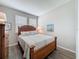 Cozy bedroom with wood-look floors, natural light, and a classic wooden bed frame at 368 Alcove Dr, Groveland, FL 34736