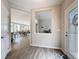 Open entryway featuring views into the living and dining area with wood-look flooring at 368 Alcove Dr, Groveland, FL 34736