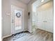 Bright entryway with decorative door, a neutral color palette, and modern wood-look flooring at 368 Alcove Dr, Groveland, FL 34736