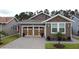 Charming home featuring a brick-paved driveway, a two-car garage and tidy landscaping at 368 Alcove Dr, Groveland, FL 34736