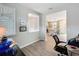 Bright home office featuring wood-look tile flooring and views into the kitchen at 368 Alcove Dr, Groveland, FL 34736