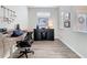 Inviting home office with wood-look tile flooring, desk and ample natural light at 368 Alcove Dr, Groveland, FL 34736