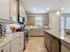 Modern kitchen featuring granite counters, stainless steel appliances and a center island with ample storage at 368 Alcove Dr, Groveland, FL 34736
