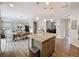 Spacious kitchen with granite island featuring seating and lots of storage; adjacent to living and dining spaces at 368 Alcove Dr, Groveland, FL 34736