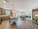 Open kitchen with stainless appliances, granite island, and an airy design flowing into dining and living spaces at 368 Alcove Dr, Groveland, FL 34736