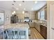 Stylish kitchen featuring granite countertops, stainless steel appliances, and a functional island with seating at 368 Alcove Dr, Groveland, FL 34736