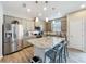 Updated kitchen with stainless steel appliances, granite countertops, and island with seating, plus ample cabinet space at 368 Alcove Dr, Groveland, FL 34736