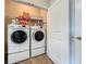 Efficient laundry room featuring a front-load washer and dryer with ample shelving at 368 Alcove Dr, Groveland, FL 34736