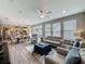 Open-concept living area with tile floors and neutral tones, flowing into a modern kitchen and dining space at 368 Alcove Dr, Groveland, FL 34736