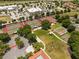 An aerial view showcases the tennis courts, basketball court, and amenity center in the community at 3684 Eversholt St, Clermont, FL 34711