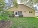 Lush green backyard features mature fruit trees and a view of the home's rear exterior at 3684 Eversholt St, Clermont, FL 34711
