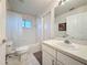A well-lit bathroom includes a vanity, mirror, and a tub with a shower featuring white tile at 3684 Eversholt St, Clermont, FL 34711