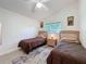 Bright bedroom with twin beds, a ceiling fan, and a window that offers plenty of natural light at 3684 Eversholt St, Clermont, FL 34711