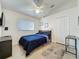 This bedroom features tile floors, a ceiling fan, and a comfortable bed at 3684 Eversholt St, Clermont, FL 34711