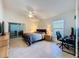 Bedroom with desk area, bed, and sliding glass doors to the lanai at 3684 Eversholt St, Clermont, FL 34711