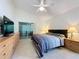 Bedroom featuring tile floors, a fan, and a sliding glass door at 3684 Eversholt St, Clermont, FL 34711