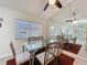 The dining area features tile flooring, a ceiling fan, and a mirrored wall providing ample light to the kitchen at 3684 Eversholt St, Clermont, FL 34711