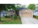 Charming single-story home with a well-manicured lawn, lovely landscaping, and an attached two-car garage at 3684 Eversholt St, Clermont, FL 34711