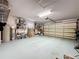 Spacious garage with ample storage shelving, open floor space, and a roll-up door at 3684 Eversholt St, Clermont, FL 34711