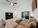 Large living room with a sectional sofa, TV, and view of the lanai at 3684 Eversholt St, Clermont, FL 34711