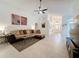 Spacious living room with tile flooring and a large sectional sofa at 3684 Eversholt St, Clermont, FL 34711