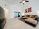 Open-concept living room showcasing tile floors and a sliding glass door at 3684 Eversholt St, Clermont, FL 34711
