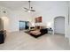 Spacious living area with a sofa, TV, and sliding glass doors at 3684 Eversholt St, Clermont, FL 34711