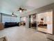 Enclosed sunroom featuring tile flooring, ceiling fans, sliding doors, and comfortable seating arrangement at 3684 Eversholt St, Clermont, FL 34711