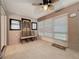 Cozy sunroom with neutral tile, chair seating, and a ceiling fan with light fixture at 3684 Eversholt St, Clermont, FL 34711