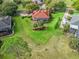 Aerial view of a single-Gathering home with a well-manicured lawn, mature trees, and a screened lanai at 39023 Griffin Lndg, Lady Lake, FL 32159