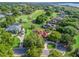 Aerial view of a single-Gathering home on a golf course, surrounded by mature trees and lush landscaping at 39023 Griffin Lndg, Lady Lake, FL 32159