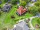 Expansive aerial view of a single-Gathering home with a well-manicured lawn, mature trees, and a screened lanai at 39023 Griffin Lndg, Lady Lake, FL 32159